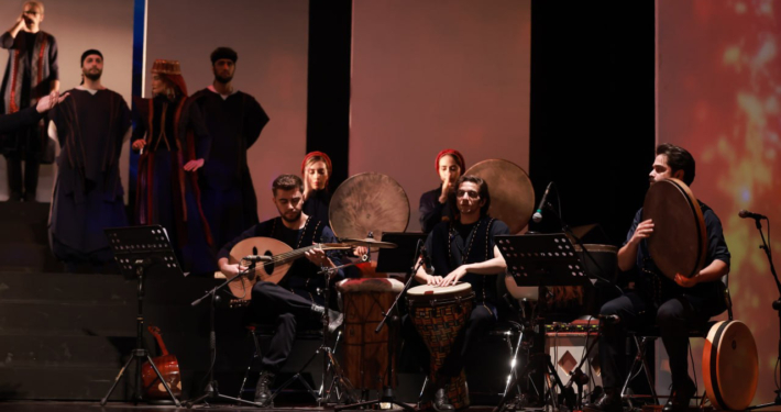 Aryan Rezaee playing the Daf as lead percussionist in the Pirouz and Parizad musical theatre at Vahdat Hall